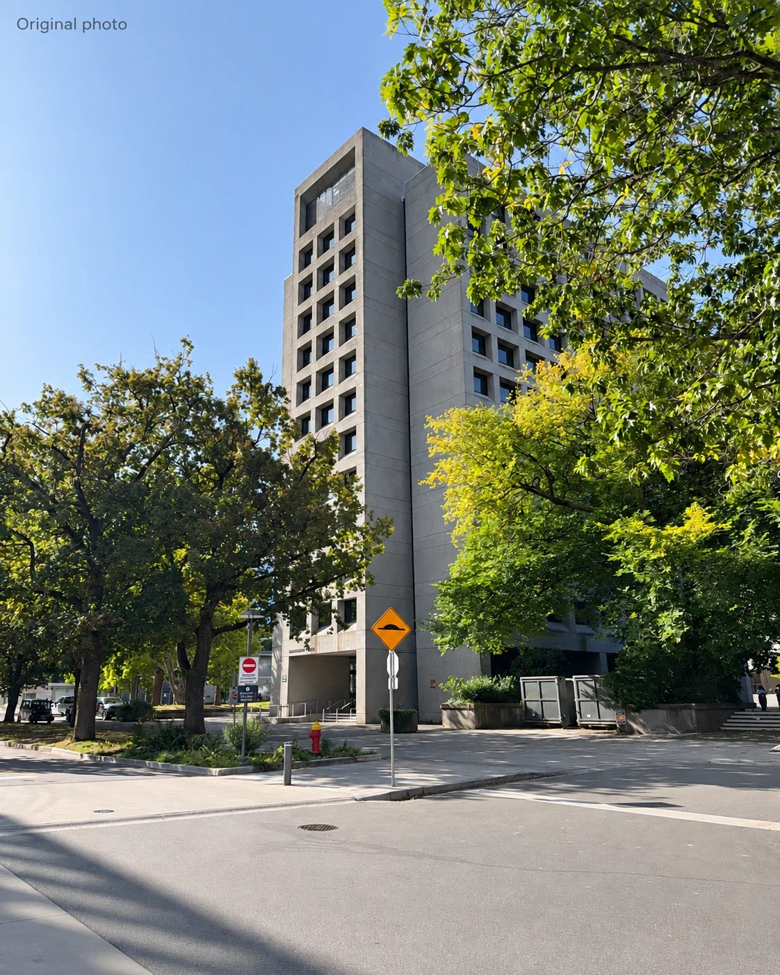 Figure 1 · Illustrative original frame: note the sky above the roof and the road and foreground below the building.